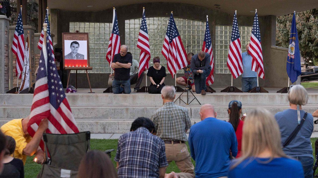 People pray as they attend a vigil for youth activist and influencer Charlie Kirk, who was shot at a public event at Utah Valley University
